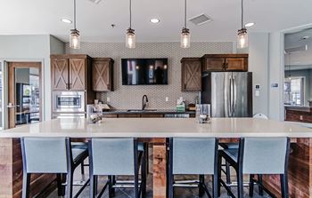 Resident lounge with kitchen, dining space and fireplace